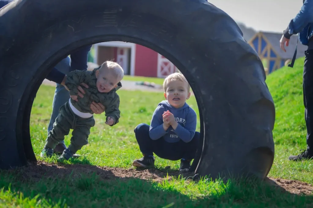 Big tyre with two small children